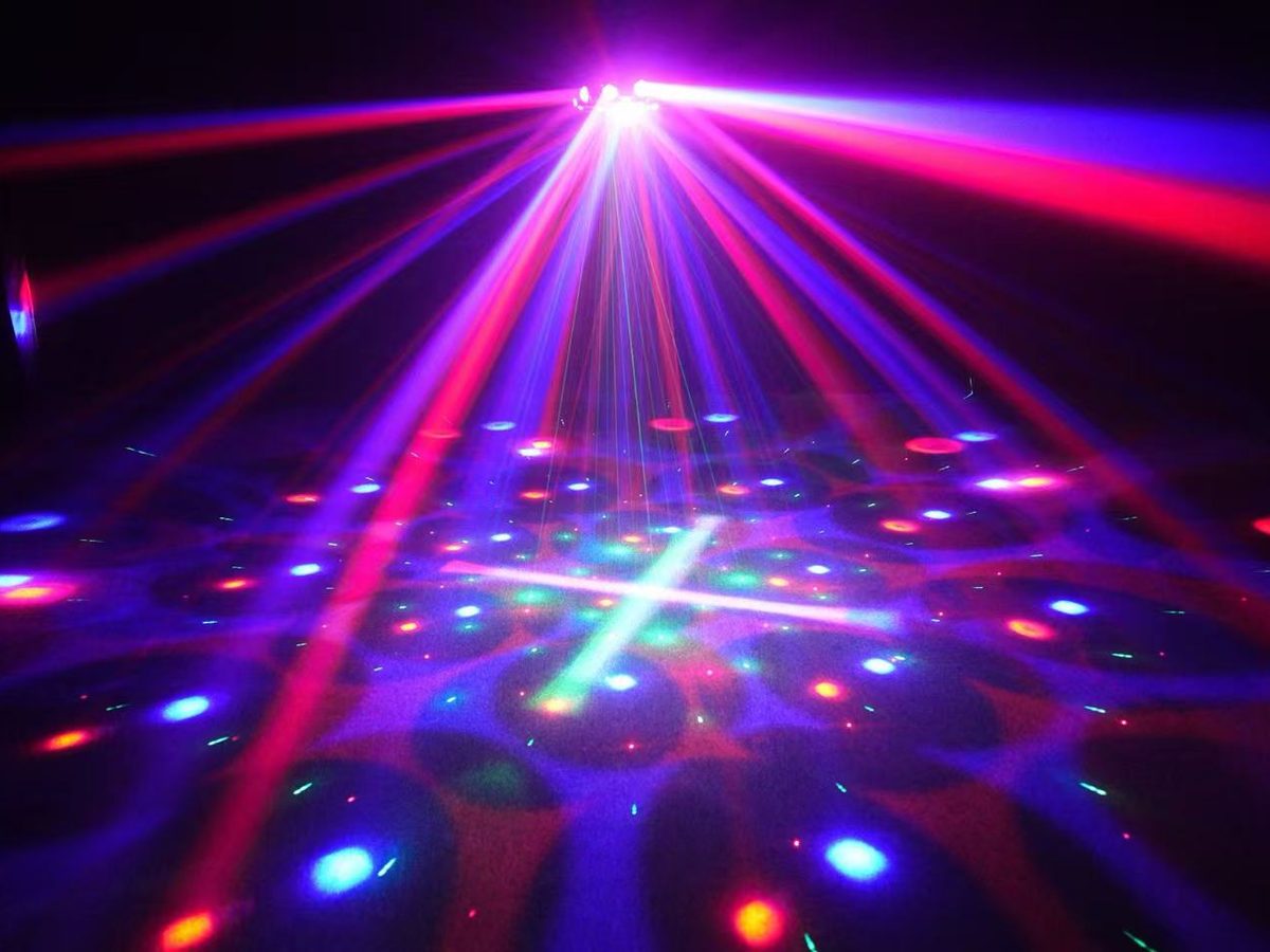 Laser beams and colour effects across a dark club ceiling
